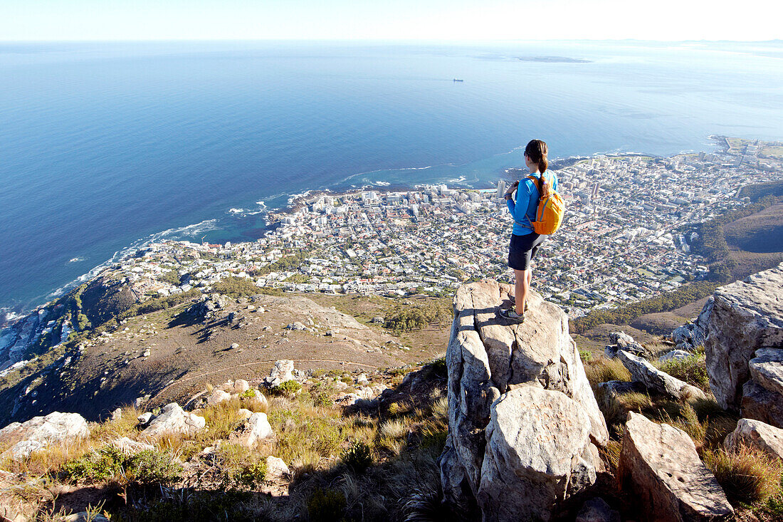 Susann Scheller standing on top of Lion's Head looking down at the city of Cape Town. South Africa.