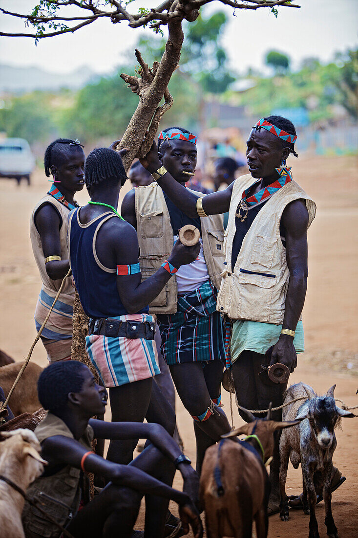 Men from the Banna tribe in Southern Ethiopia wear short,bright colored skirts, a leather belt with many pouches, a knife in a traditional beaded holder and  also they always carry their headrest with them, they not only use this headrest to sleep on, but