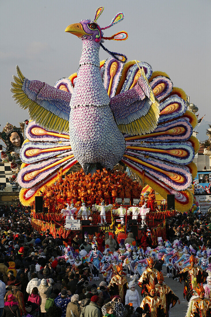 Masks and caricatures of politicians singing and dancing in the streets and enormous paper mache floats, surrounded by thousands of people, in the great celebration of the Carnival of Viareggio.