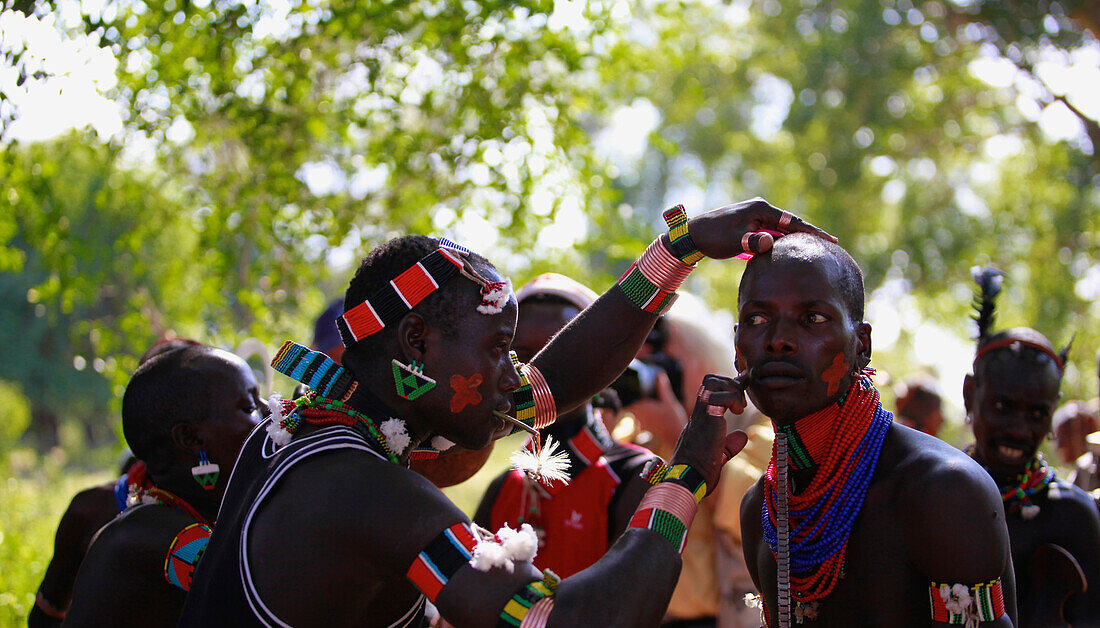 The Maza, the ones who will whip the women are a group of men who have already leapt across the cattle, and live apart from the rest of the tribe, moving from ceremony to ceremony.   Bull Jumping Ceremony, Omo valley, Dimeka,Ethiopia, 2010.