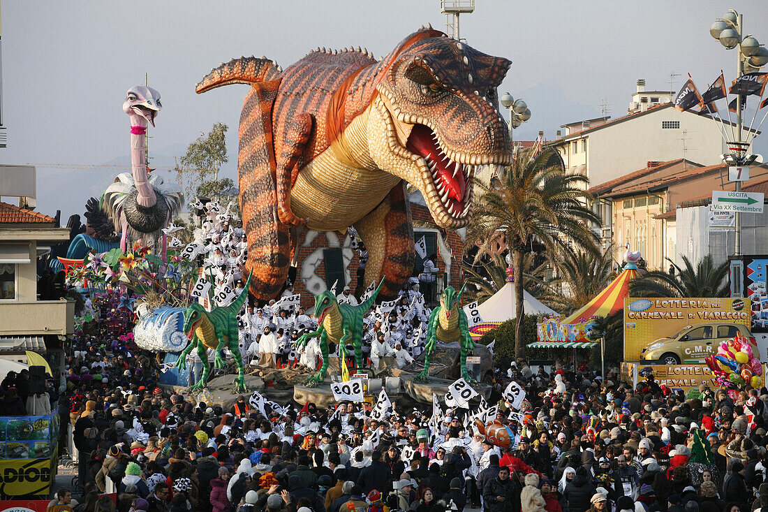 Masks and caricatures of politicians singing and dancing in the streets and enormous paper mache floats, surrounded by thousands of people, in the great celebration of the Carnival of Viareggio.