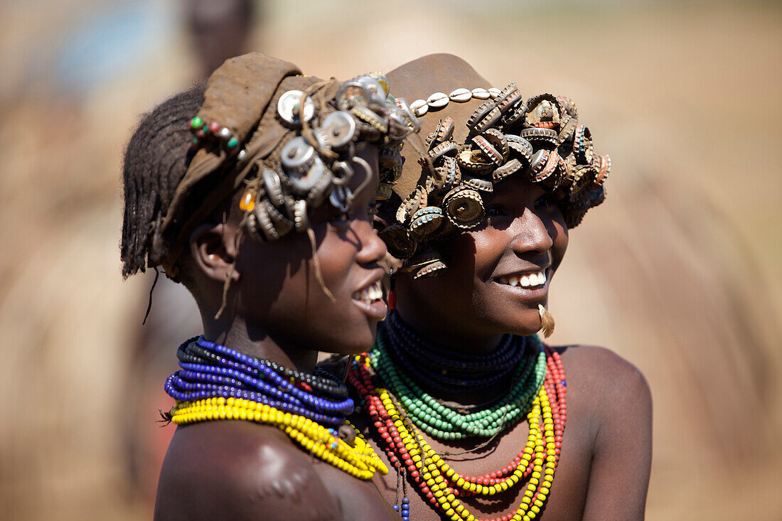 Women in the Bumi tribe decorate their hats with bottlecaps , Omo valley, Ethiopia,2010
