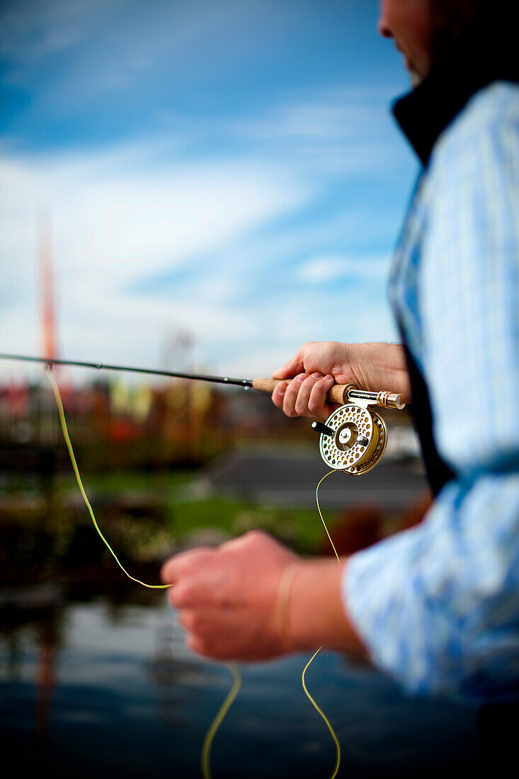 A man practices his fly fishing outside the Orvis store in Bend, Oregon.