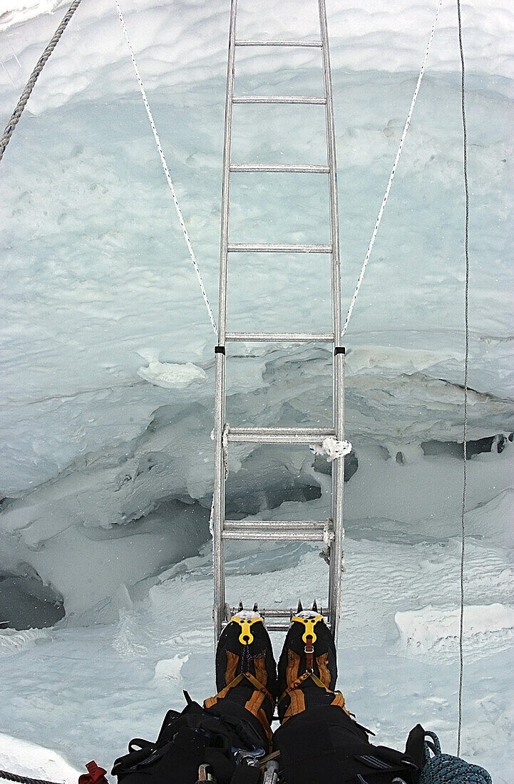 Don't look down: Crossing a ladder-bridge in the Khumbu Icefall, Everest, Nepal.