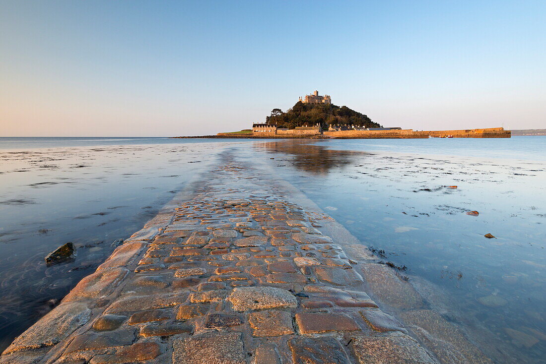The stone causeway leading to St. Michaels Mount in early morning sunshine, Marazion, Cornwall, England, United Kingdom, Europe