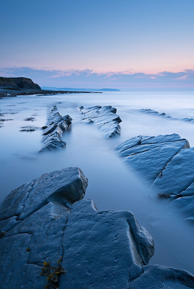 Twilight skies above rocky coast at Kilve Beach, Somerset, England, United Kingdom, Europe