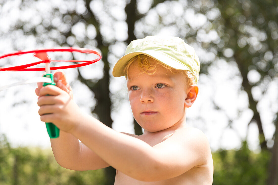 Boy (4 years) playing with toy, Marielyst, Falster, Denmark