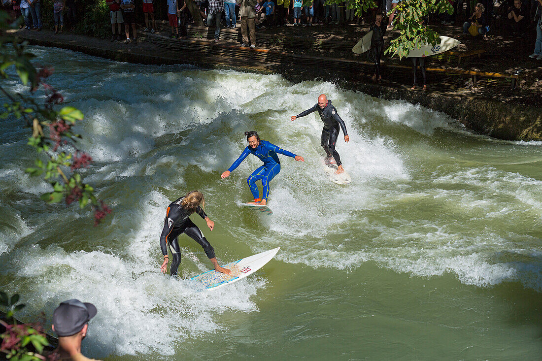 Surfers on the Eisbach river in the English Gardens, Munich, Upper Bavaria, Bavaria, Germany