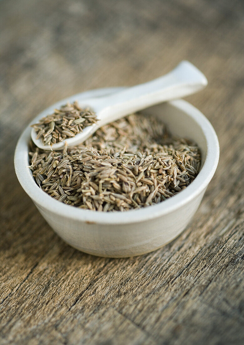 Cumin seeds in bowl, with spoon