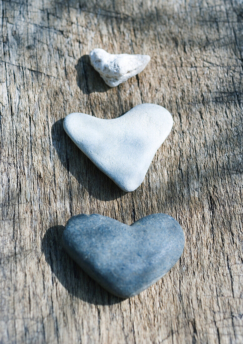 Heart-shaped stones on wood