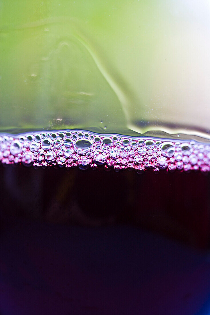 Tiny bubbles on surface of red wine