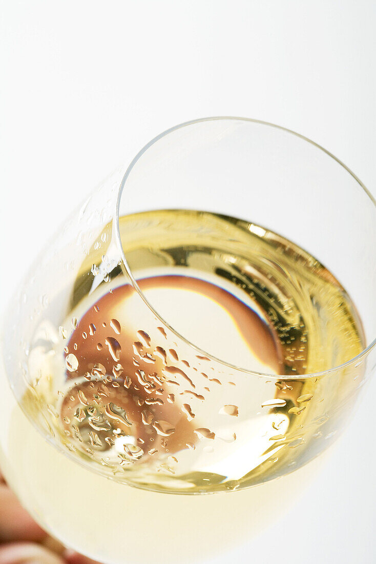 Glass of chilled white wine, close-up, high angle view