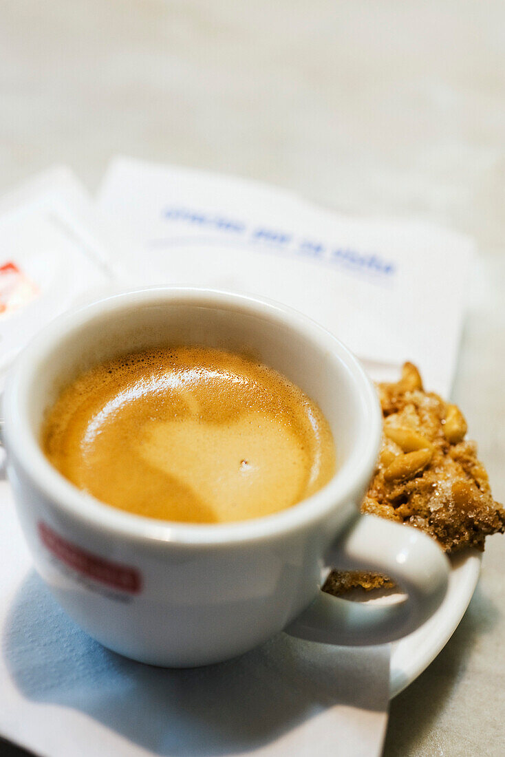 Cup of coffee with cookie, high angle view