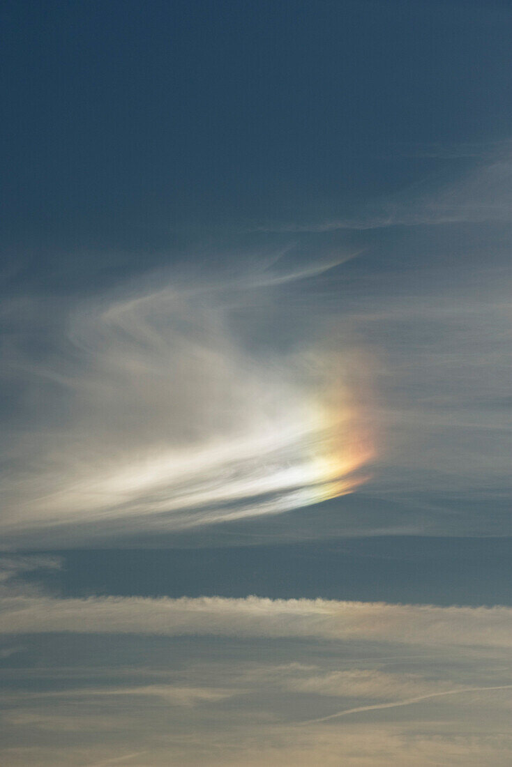 Cloudscape with partial rainbow