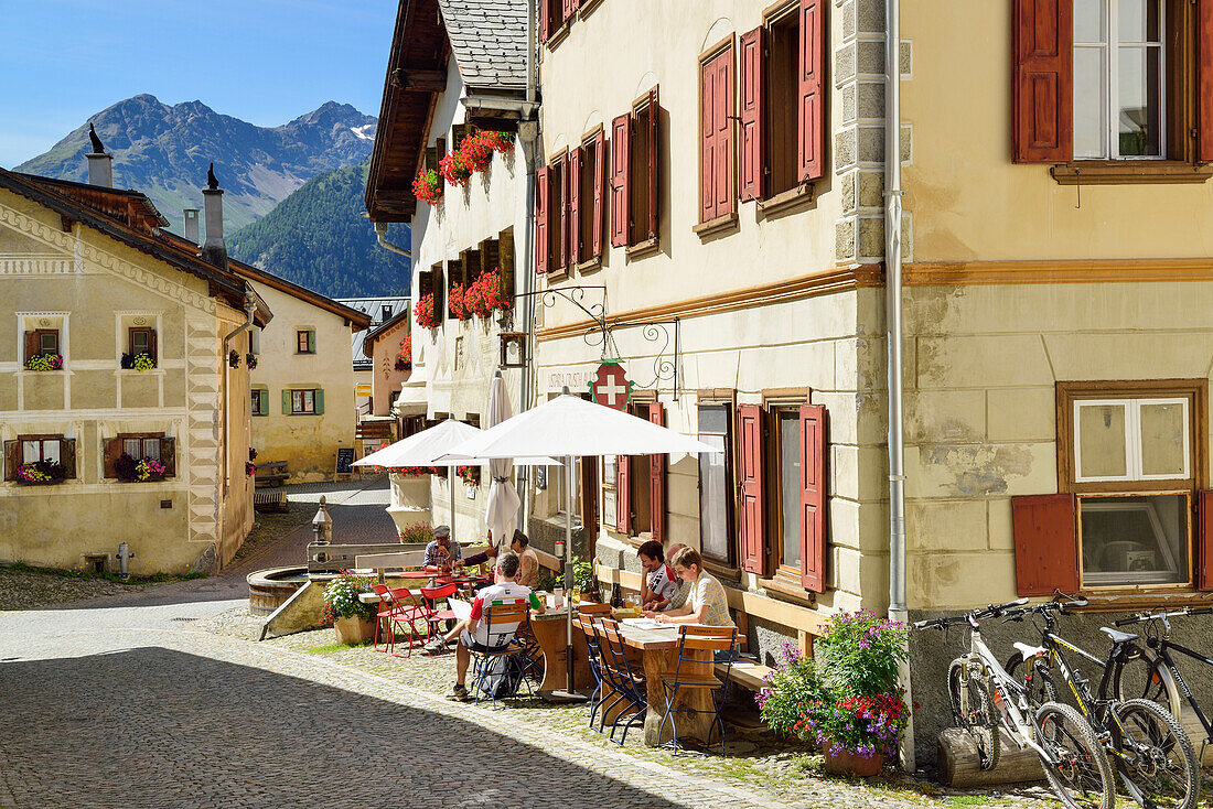 Guests in a pavement cafe, Guarda, Lower Engadin, Canton of Graubuenden, Switzerland