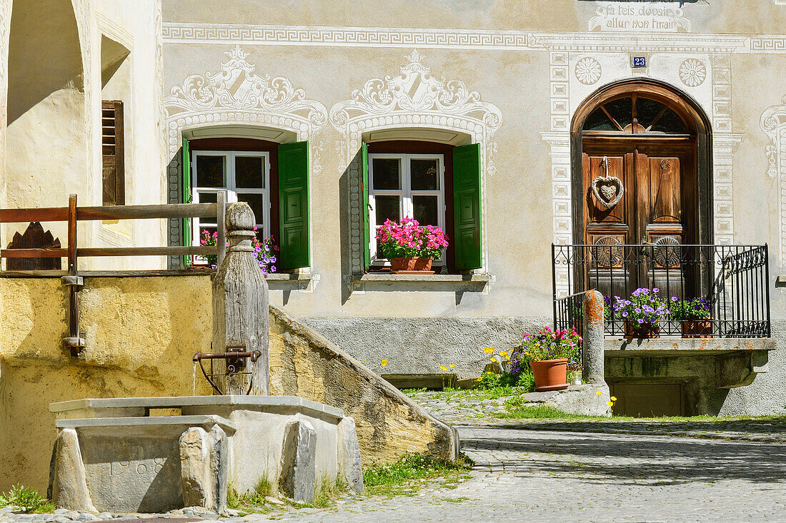 Fountain near a Engadin house, Guarda, Lower Engadin, Canton of Graubuenden, Switzerland