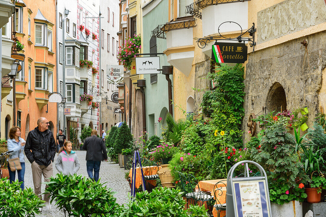 Persons walking along an alley in old town, Hall, Tyrol, Austria