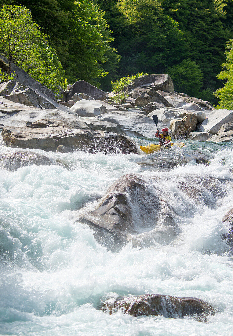 Kayaker in »Lucifer's« on the crystal clear waters of the Verzasca, Ticino, Switzerland