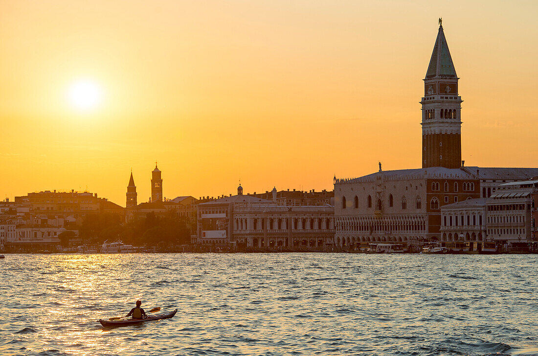 Paddler at sunset in front of Piazza San Marco, Venice, Italy