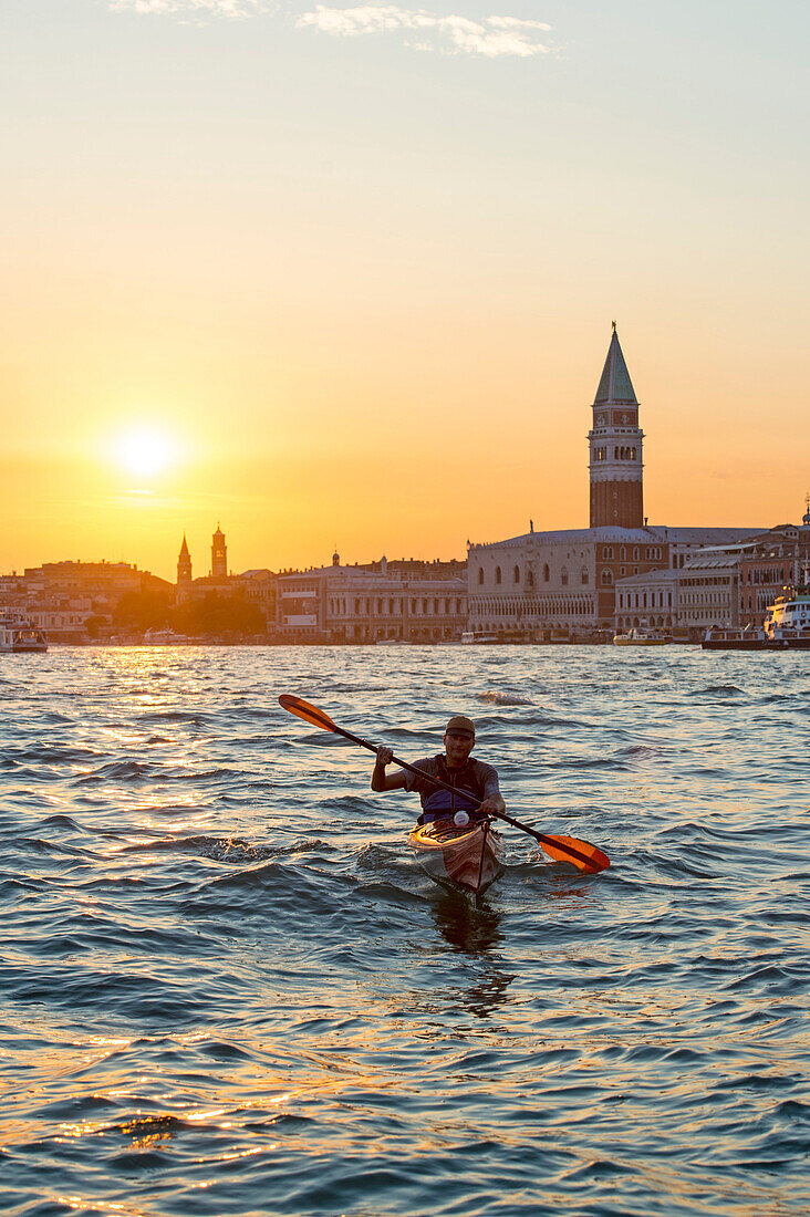 Paddler at sunset in front of Piazza San Marco, Venice, Italy