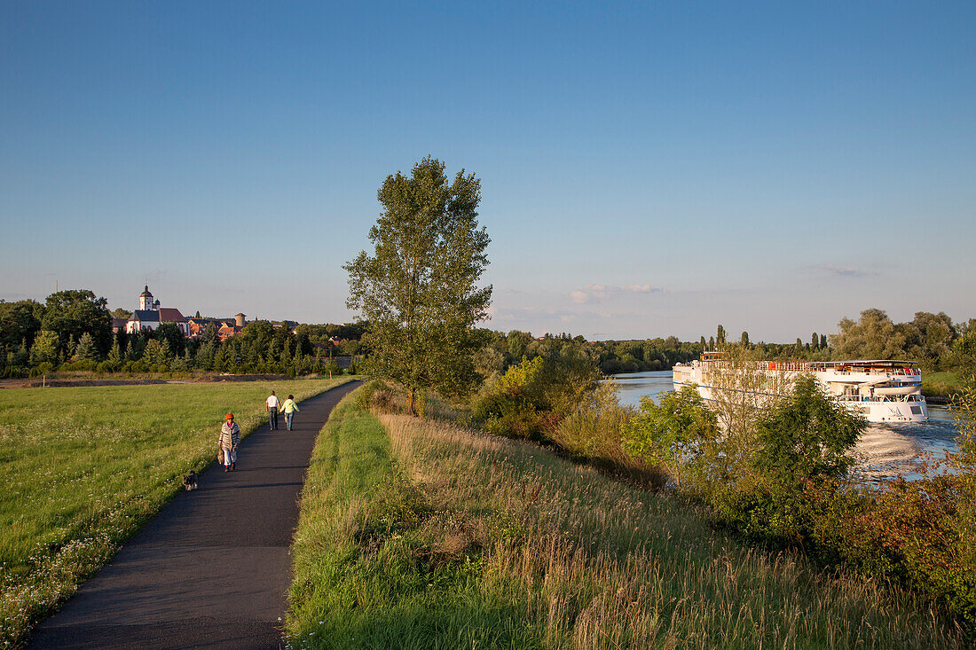 People on the path along the Main river with river cruise ship River Cloud II (Sea Cloud Cruises), Dettelbach, near Kitzingen, Franconia, Bavaria, Germany