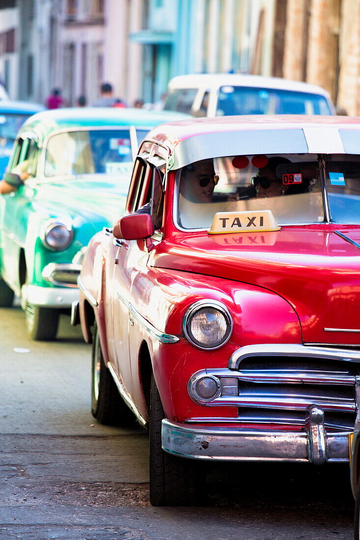 Vintage American cars used as local taxis, driving down Avenue Colon during afternoon rush hour, Havana Centro, Havana, Cuba, West Indies, Central America