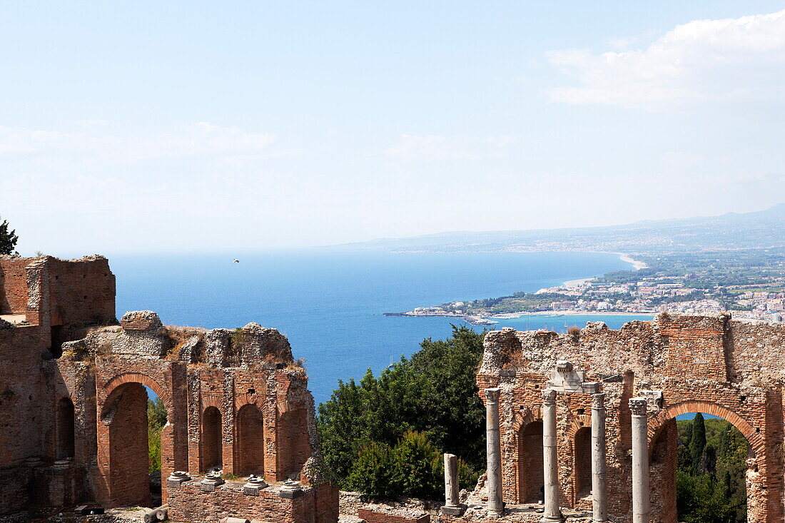 View over the Naxos coast from the Greek Roman theatre of Taormina, Sicily, Italy, Europe