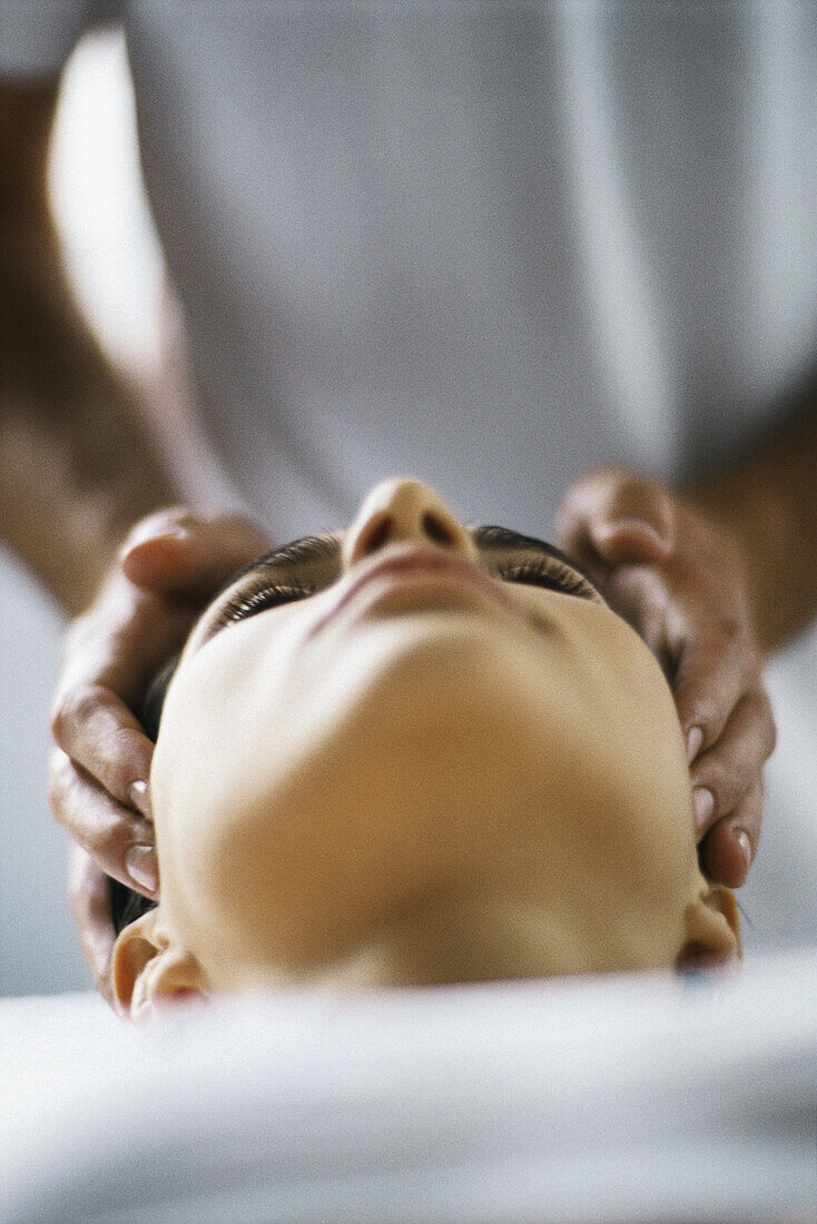 Woman receiving head massage