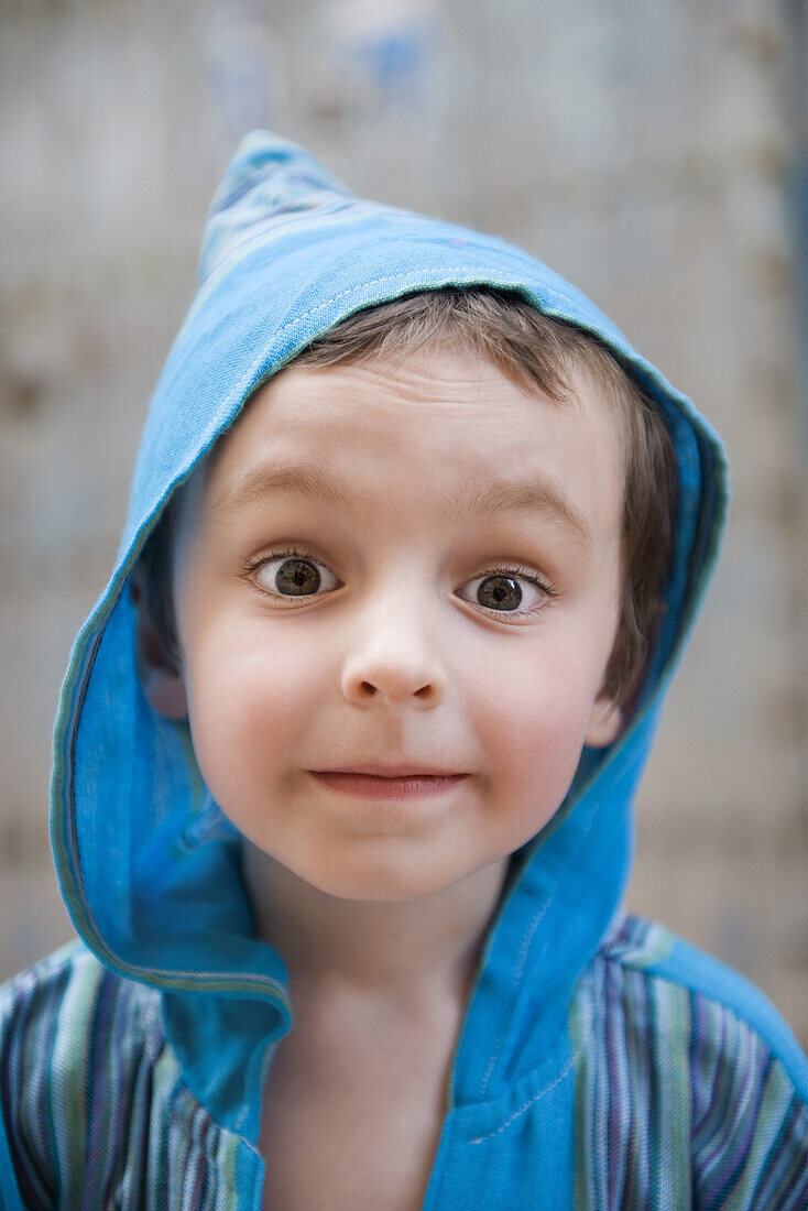 Little boy looking at camera with surprised expression, portrait