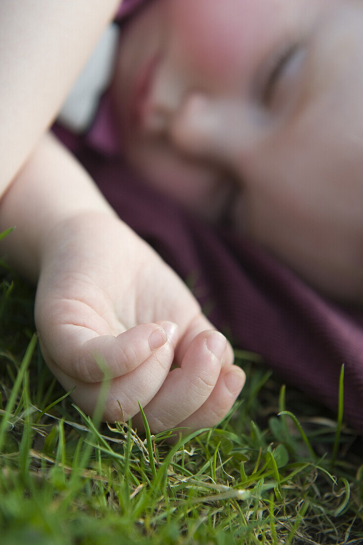 Baby girl napping on grass