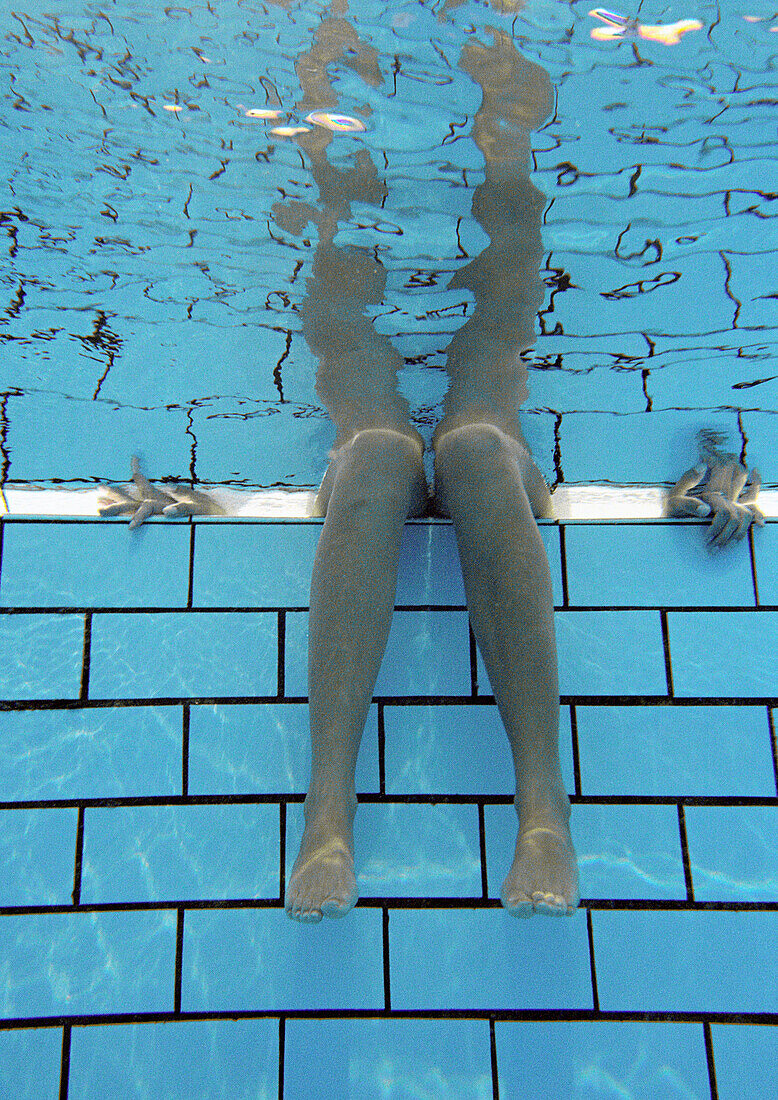 Woman, legs underwater, underwater view.