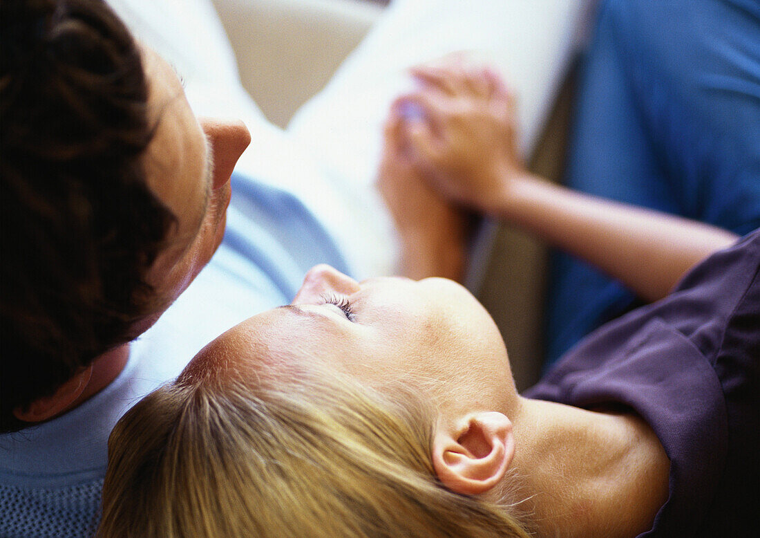 Woman leaning head on man's shoulder, close-up