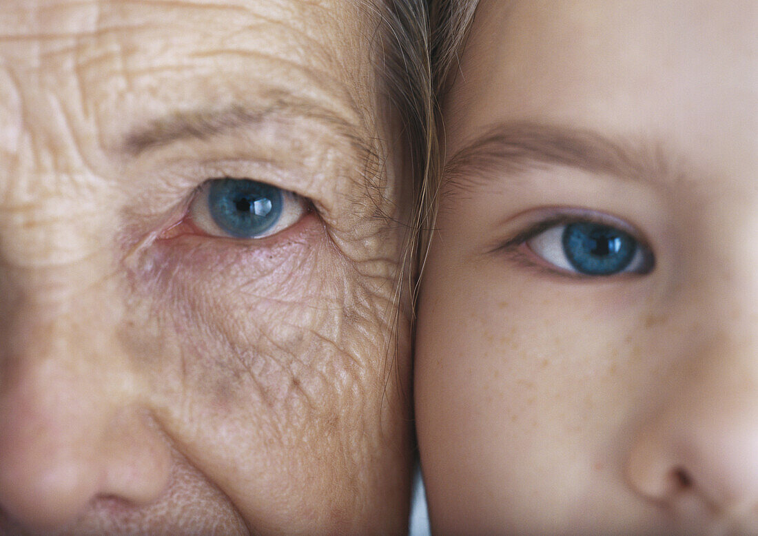 Grandmother and granddaughter cheek to cheek, extreme close-up