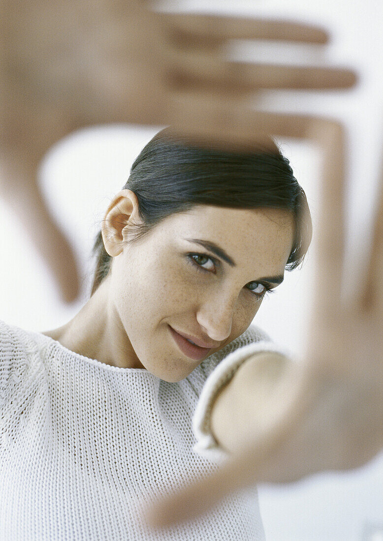 Woman framing with hands, portrait