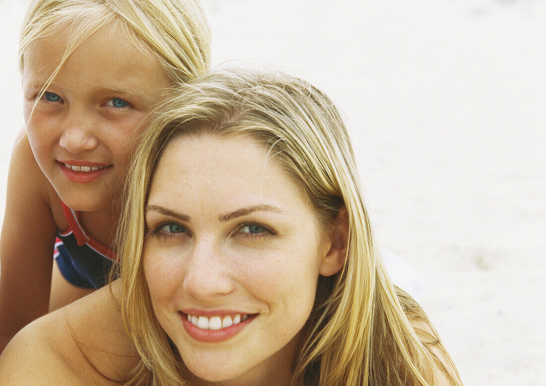 Girl and mother on beach, portrait