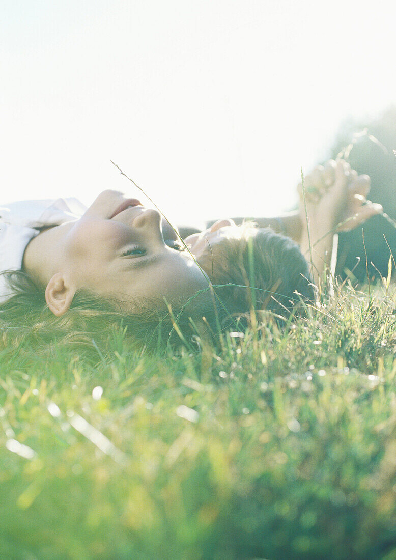 Boy and girl lying on grass together