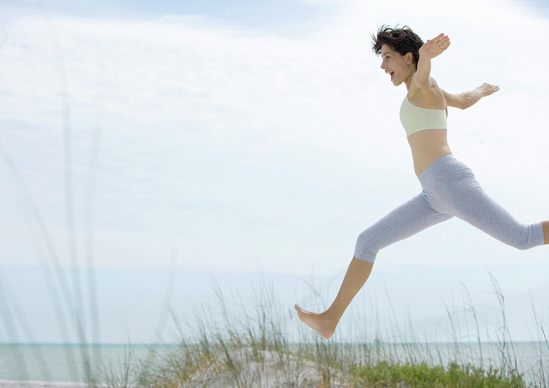 Woman jumping in dunes