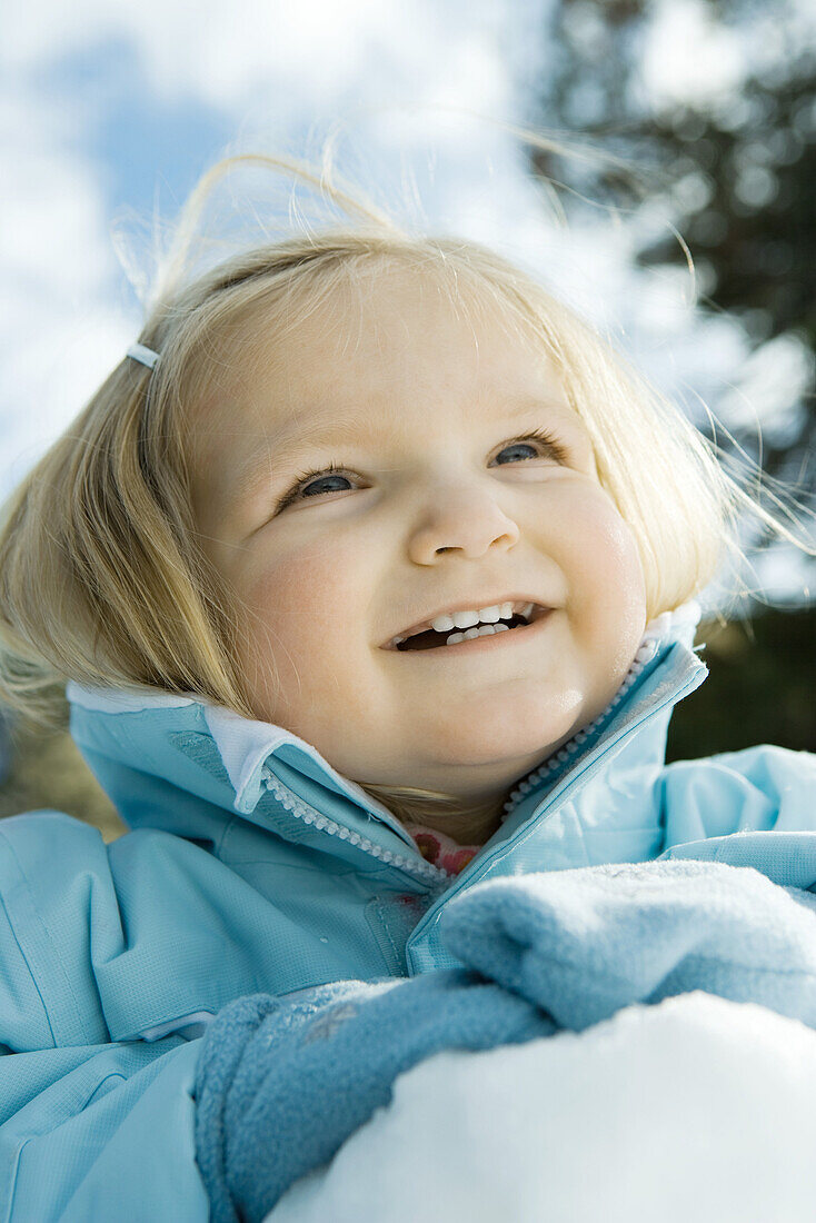 Toddler girl in snow, close-up, portrait