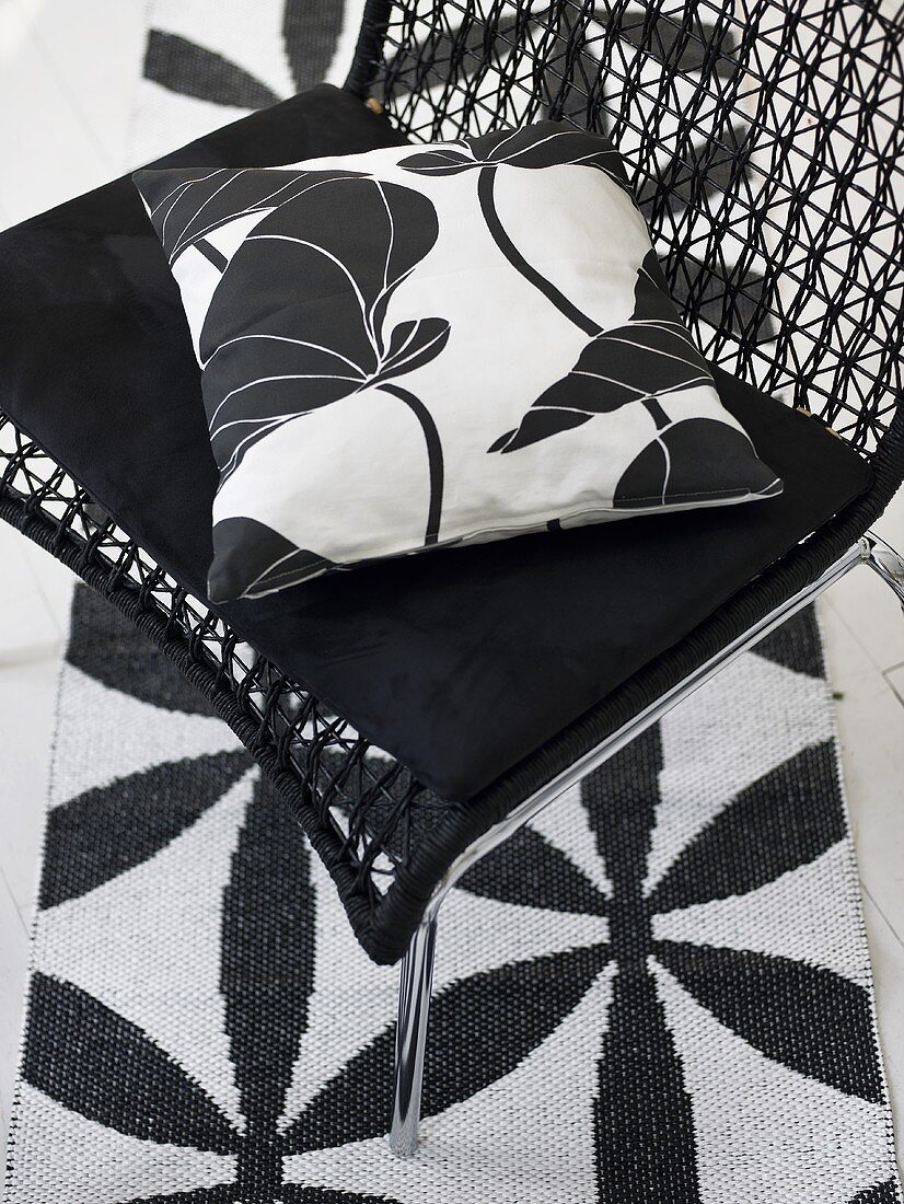 Black and white pillows on a mesh chair