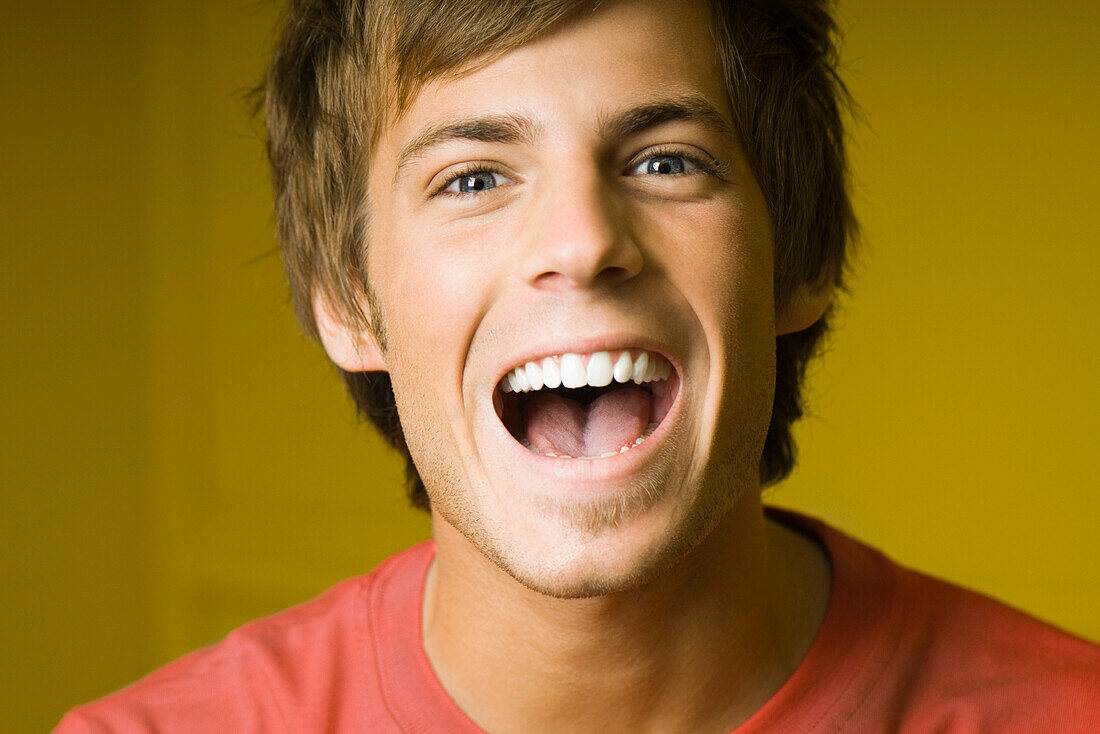 Young man laughing, portrait