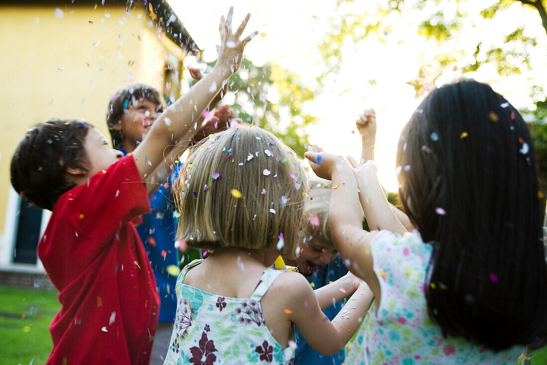 Children showered in falling confetti