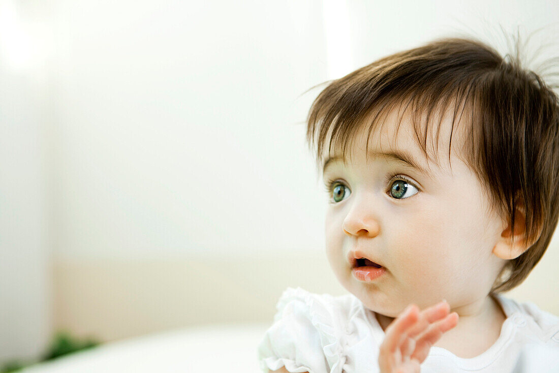 Baby girl with startled expression, portrait