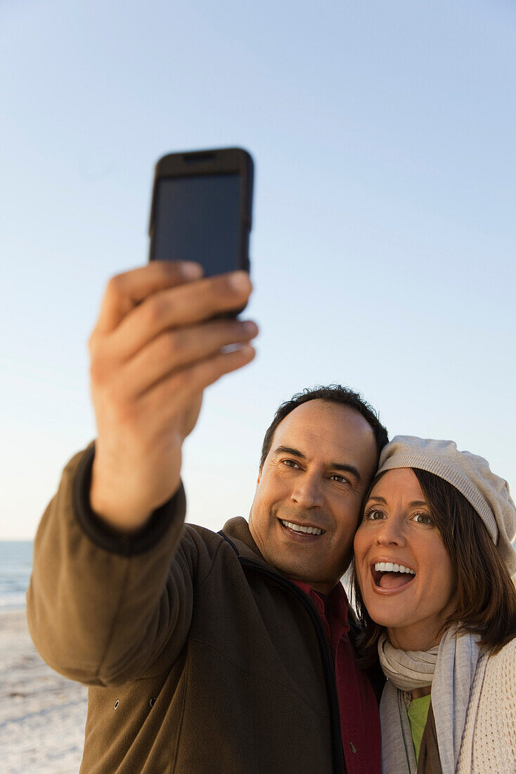 Mature couple photographing themselves with photophone
