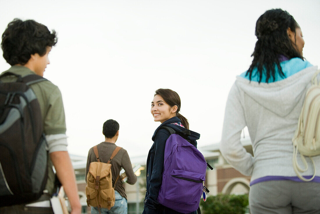 Teenage girl walking with classmates