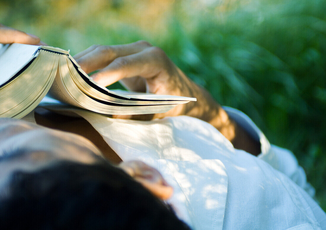 Man sleeping with book on chest, close-up