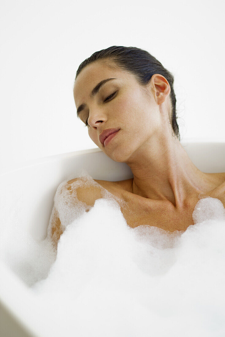 Mid-adult woman relaxing in bubble bath