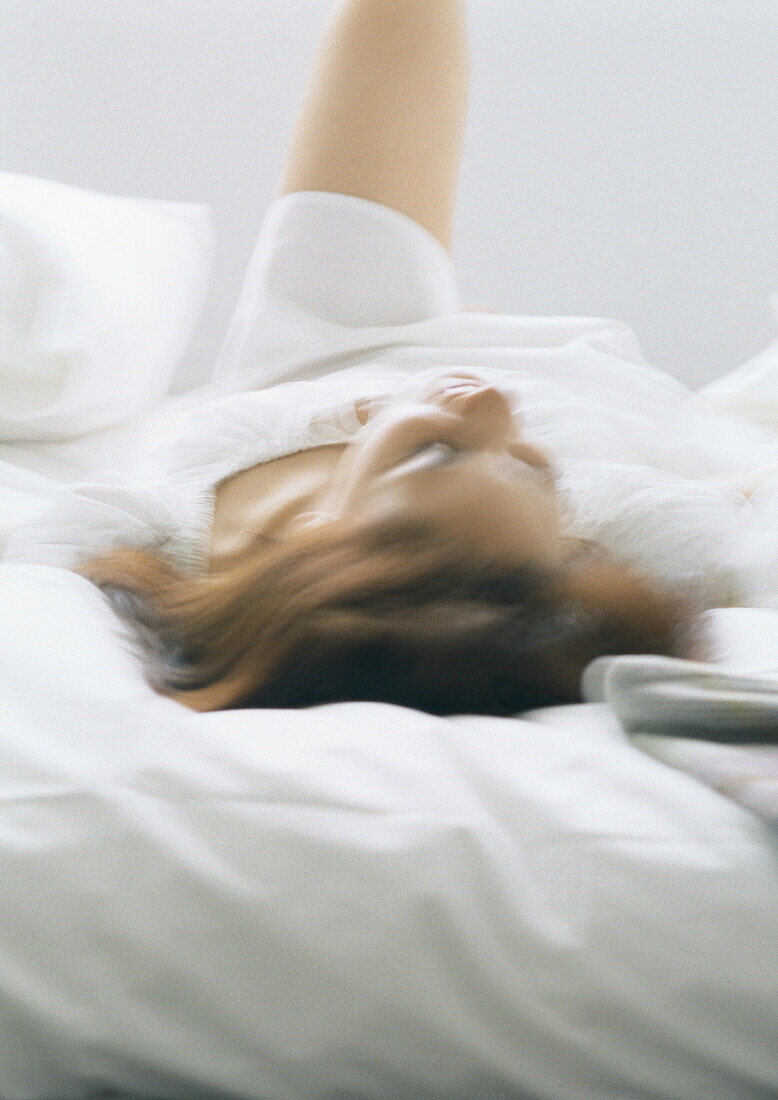 Woman lying on bed