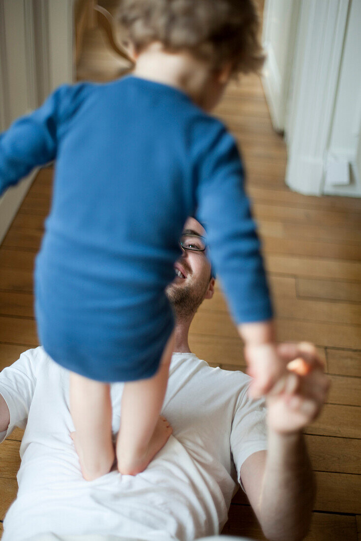 Father playing with toddler son