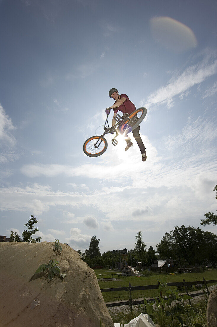 A BMX rider doing a stunt in mid-air