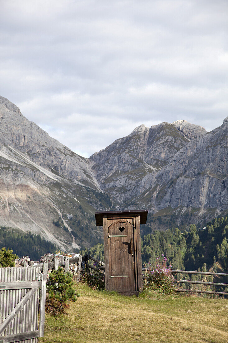 An outhouse in a mountain setting